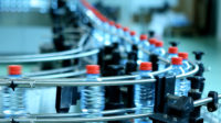 2024 State of Converting feature image of water bottles on a conveyor in a factory.